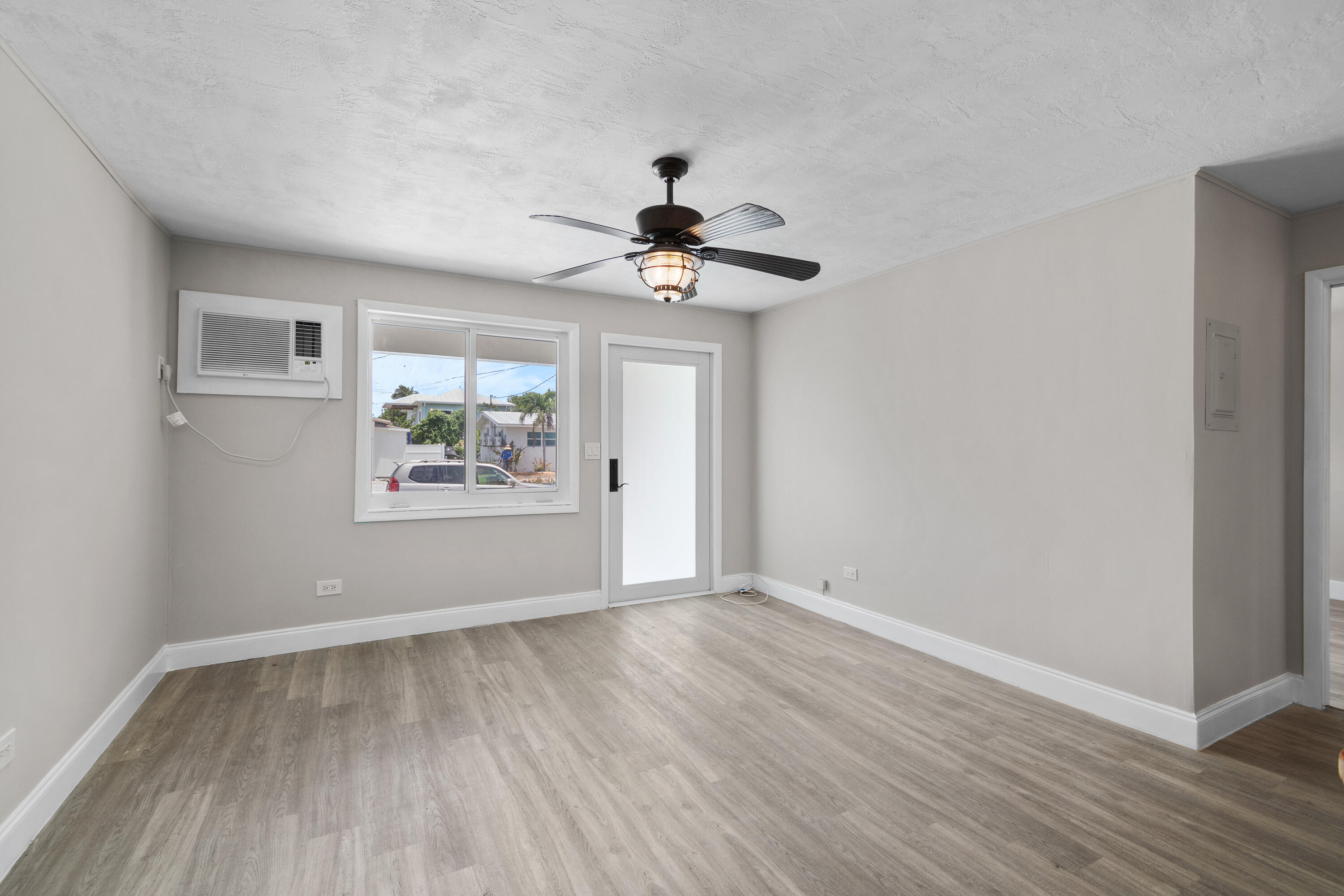 10873 7th Ave Gulf Marathon, FL 33050 - Photo 14 of 25 a view of an empty room with window and wooden floor