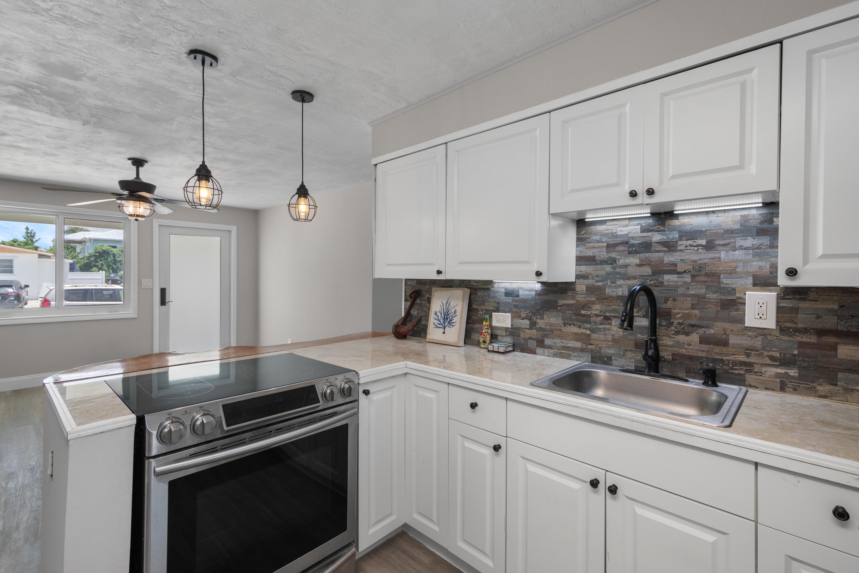 10873 7th Ave Gulf Marathon, FL 33050 - Photo 15 of 25 a kitchen with a sink stove and cabinets