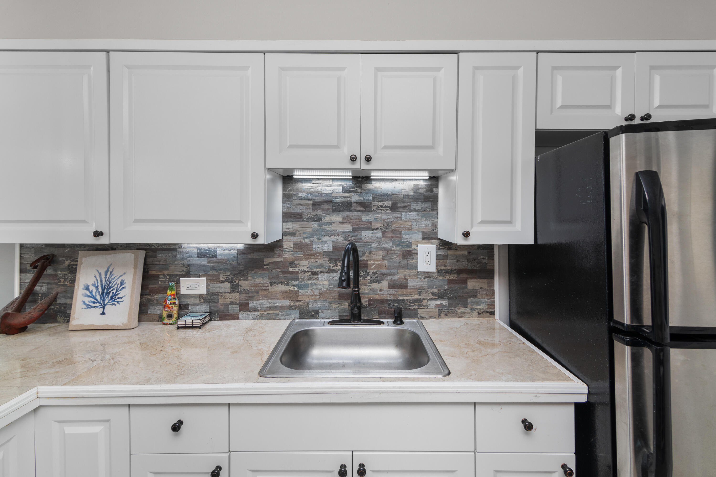10873 7th Ave Gulf Marathon, FL 33050 - Photo 16 of 25 a kitchen with a refrigerator sink and cabinets