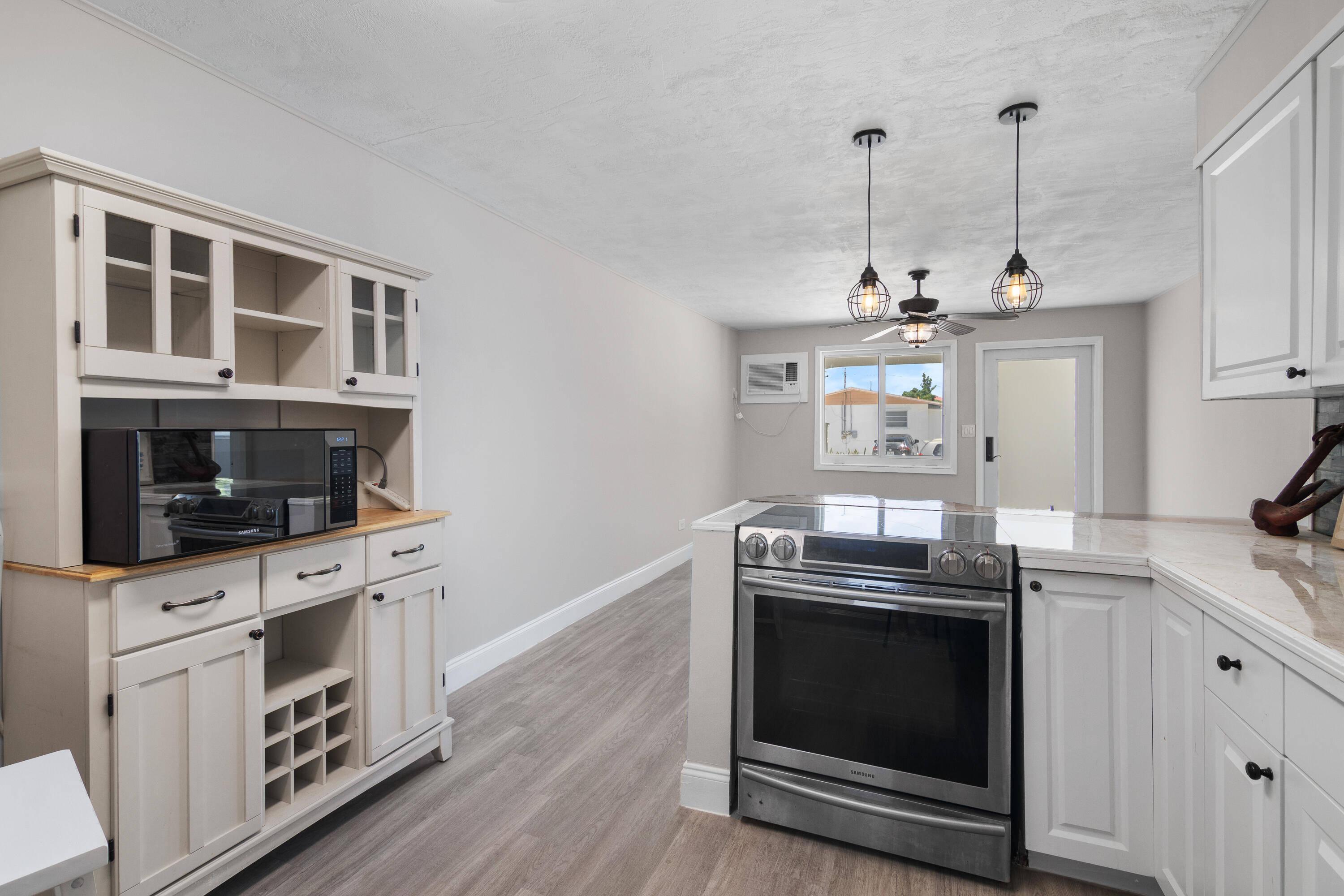 10873 7th Ave Gulf Marathon, FL 33050 - Photo 19 of 25 a kitchen with stainless steel appliances granite countertop a stove and a wooden floor