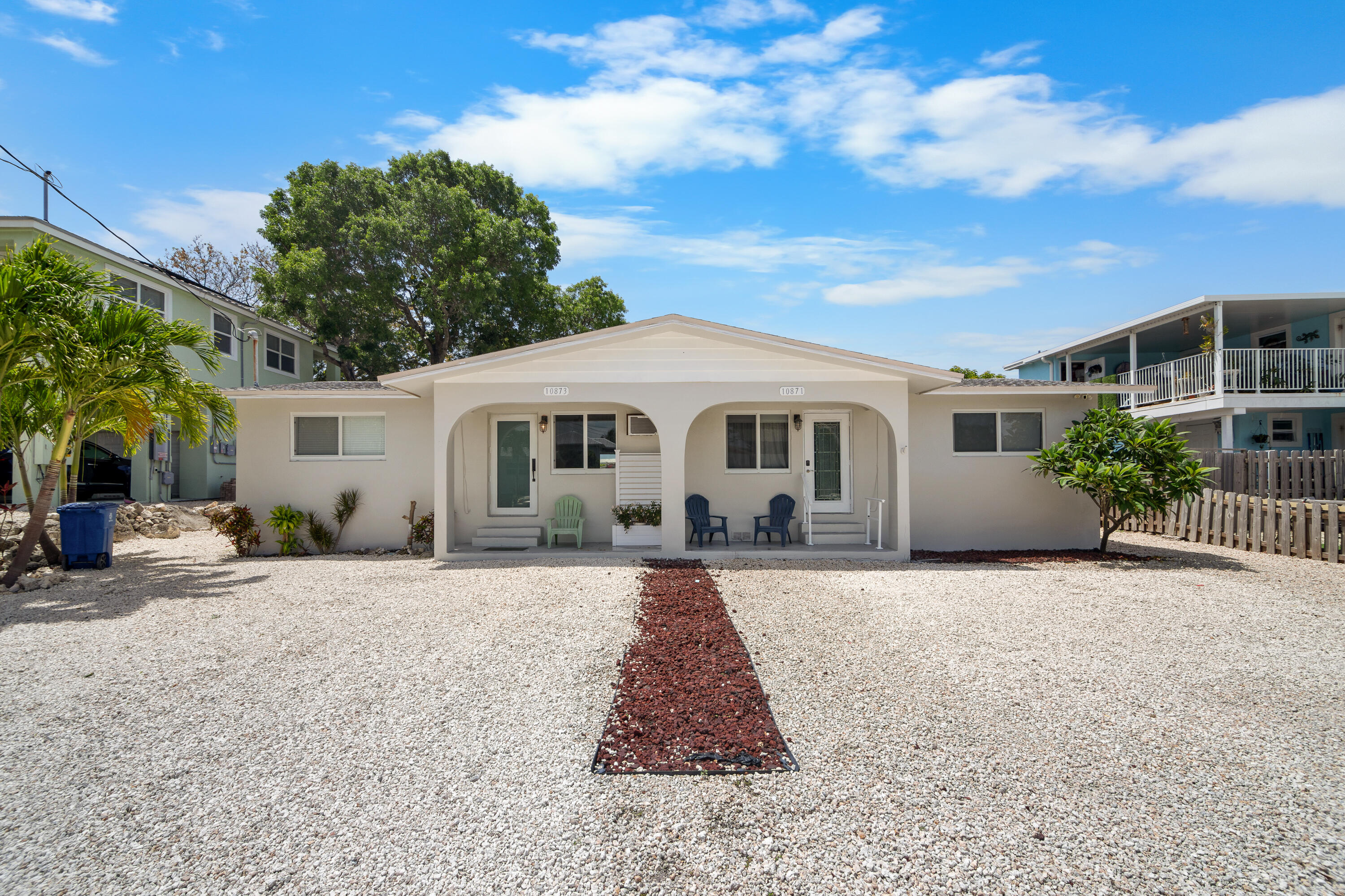 10873 7th Ave Gulf Marathon, FL 33050 - Photo 2 of 25 a front view of a house with a yard