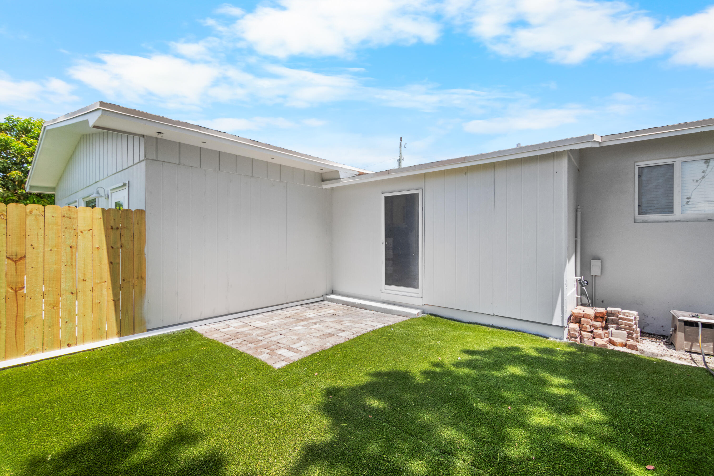 10873 7th Ave Gulf Marathon, FL 33050 - Photo 3 of 25 a backyard of a house with plants and wooden fence
