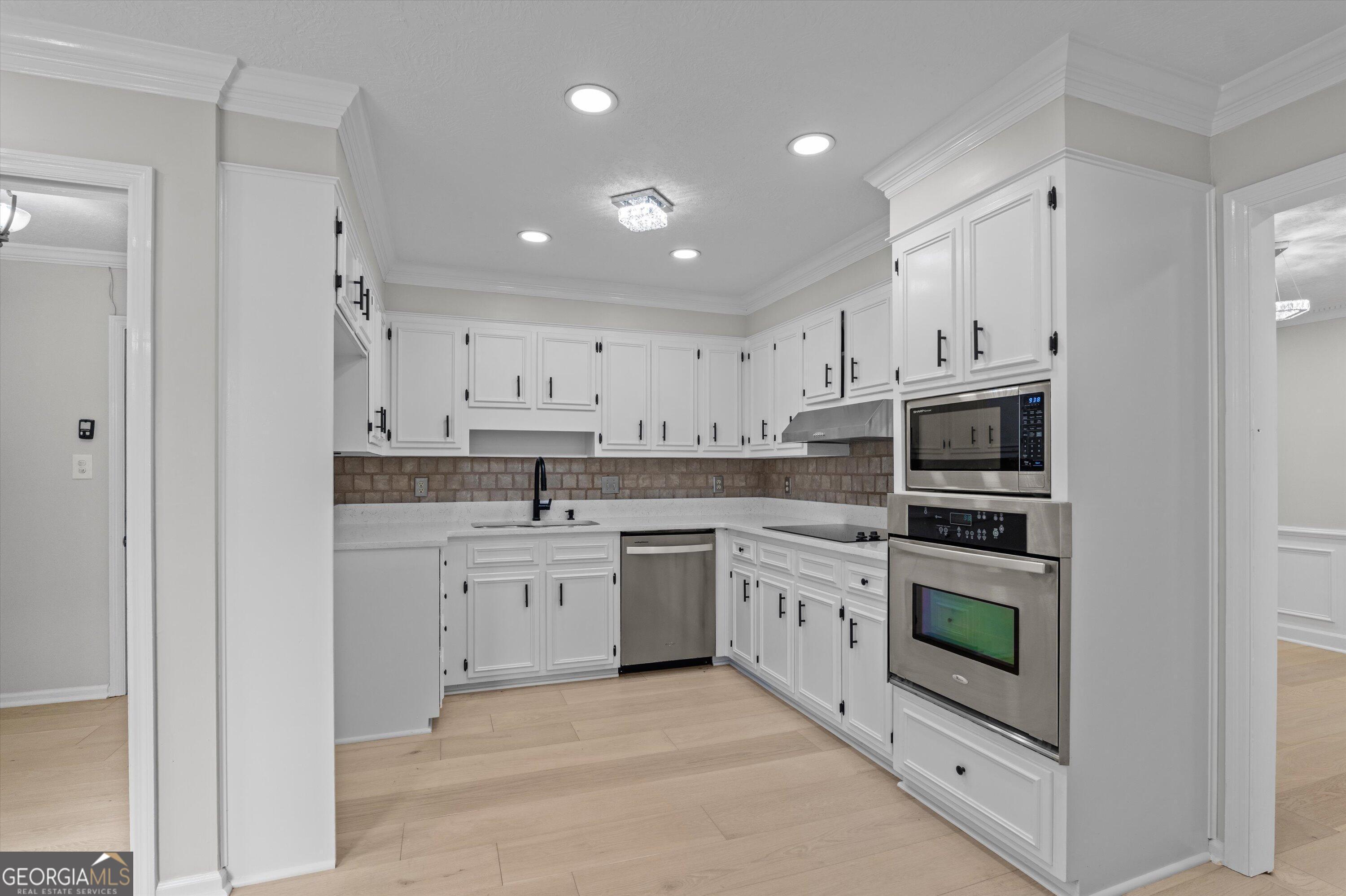 2507 Pinebluff Court Augusta, GA 30909 - Photo 21 of 56 a kitchen with white cabinets stainless steel appliances and sink