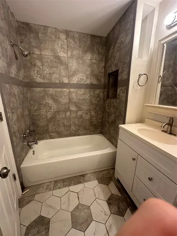 a bathroom with a sink a toilet and bathtub