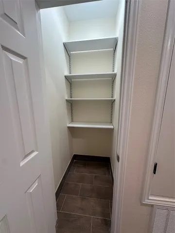 a storage room with a wooden shelf