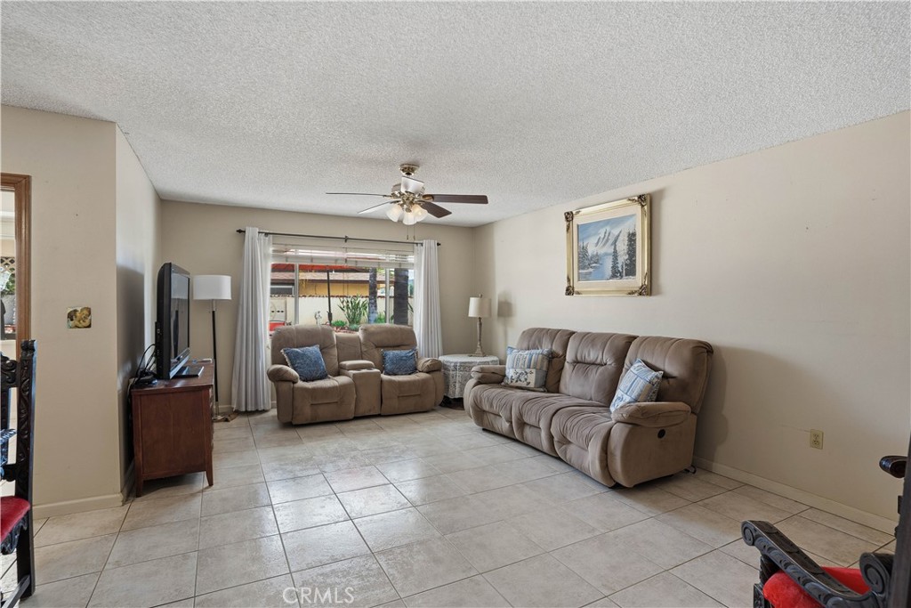25990 Roanoke Road Menifee, CA 92586 - Photo 12 of 47 a living room with furniture and a flat screen tv