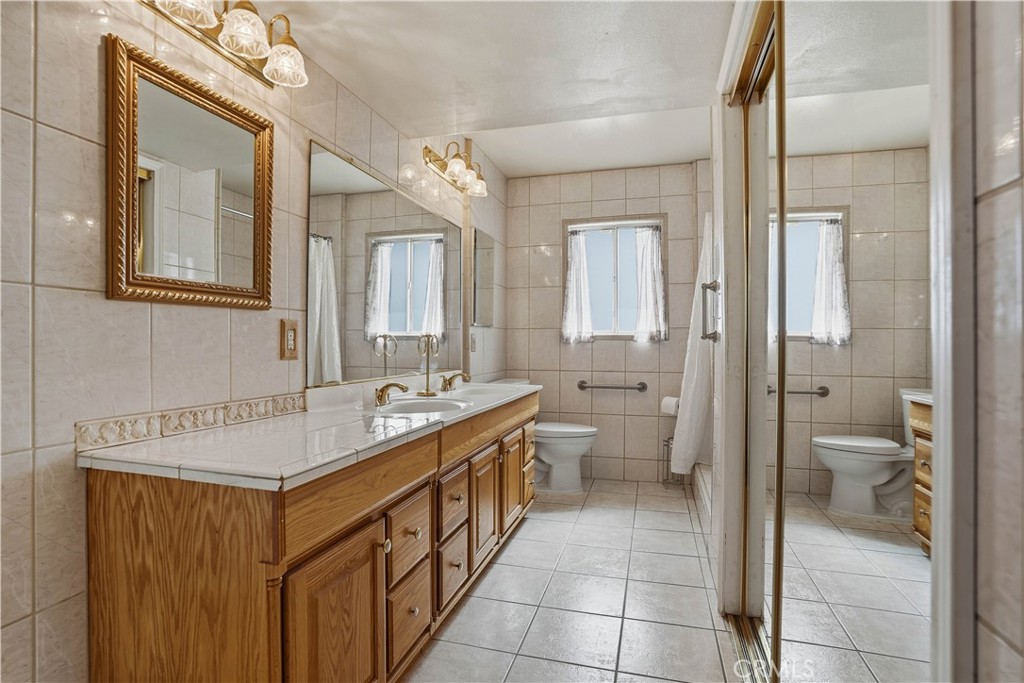 25990 Roanoke Road Menifee, CA 92586 - Photo 19 of 47 a bathroom with a sink and mirror with toilet