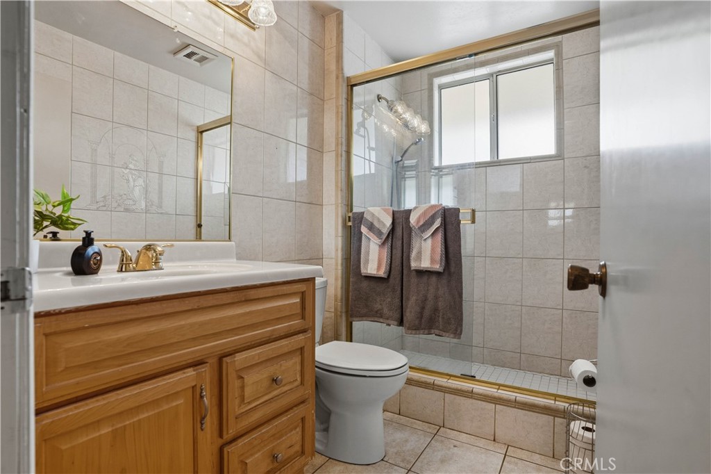 25990 Roanoke Road Menifee, CA 92586 - Photo 27 of 47 a bathroom with a sink a toilet and shower