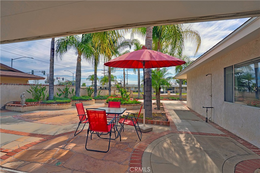 25990 Roanoke Road Menifee, CA 92586 - Photo 35 of 47 a view of a patio with a table chairs and a backyard