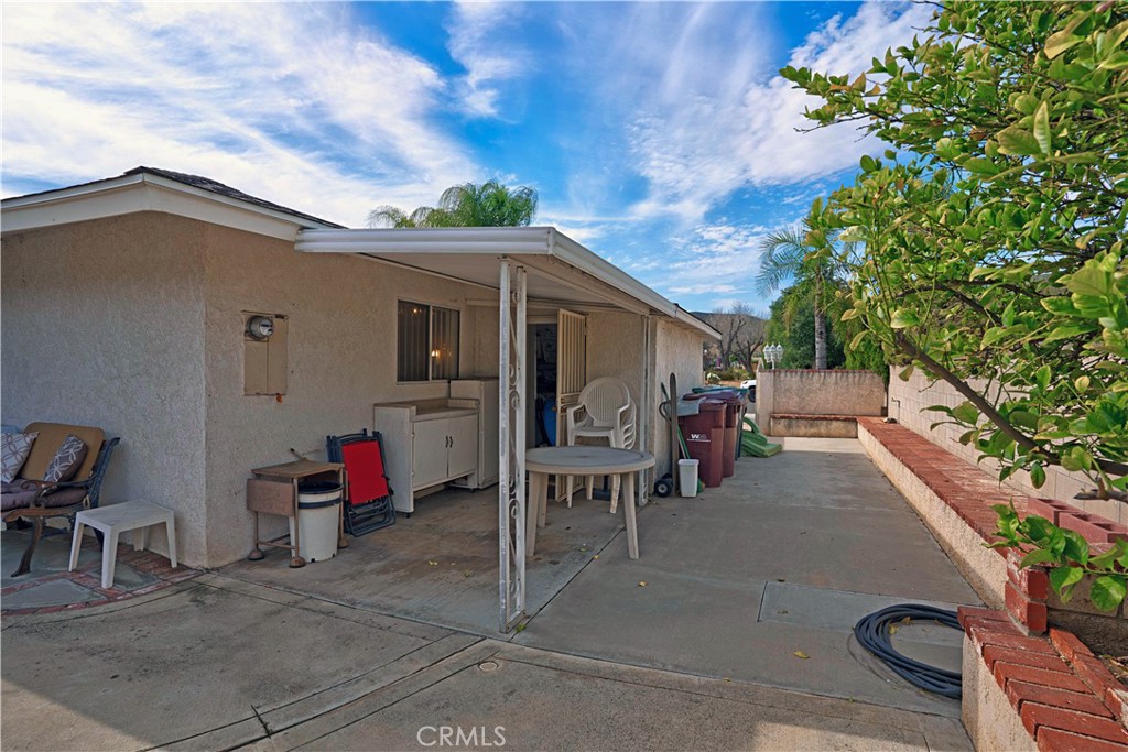 25990 Roanoke Road Menifee, CA 92586 - Photo 42 of 47 a view of a patio with table and chairs and potted plants