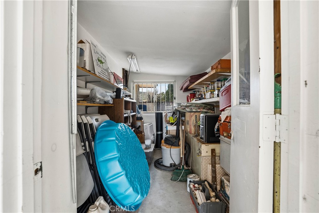 25990 Roanoke Road Menifee, CA 92586 - Photo 43 of 47 a view of walk in closet with clothes and shoes