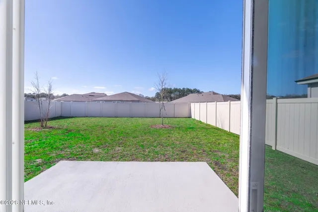 a view of a backyard with a garden and plants