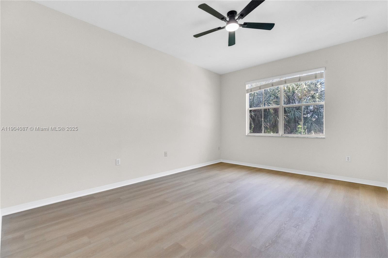 3459 Merrick Lane, Unit 501 Margate, FL 33063 - Photo 11 of 26 a view of an empty room with wooden floor and a window