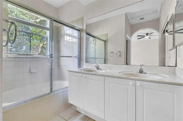 a bathroom with a double vanity sink and mirror