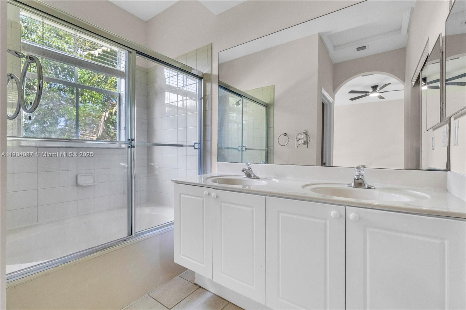 3459 Merrick Lane, Unit 501 Margate, FL 33063 - Photo 16 of 26 a bathroom with a double vanity sink and mirror