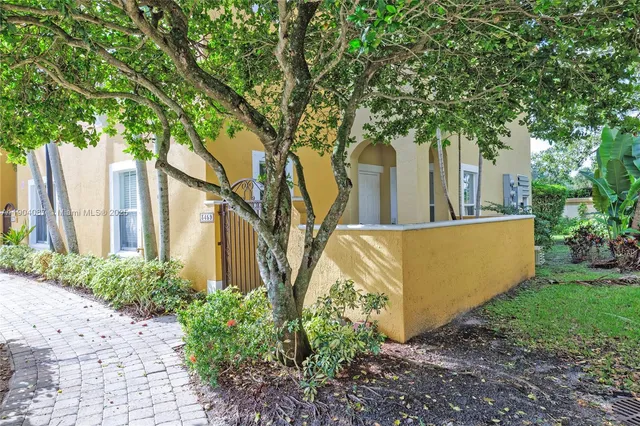 a view of a house with a tree in a yard