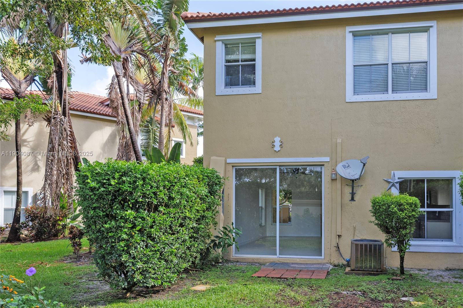 3459 Merrick Lane, Unit 501 Margate, FL 33063 - Photo 25 of 26 a front view of a house with garden