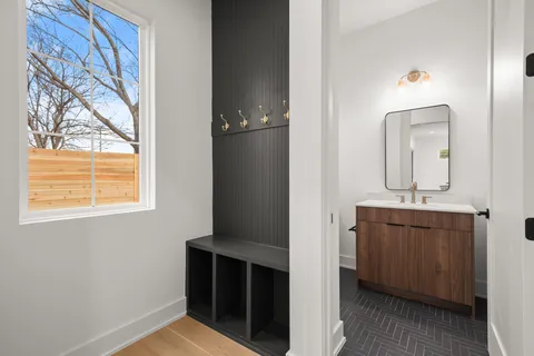 a bathroom with a shower sink and mirror
