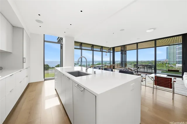 a large white kitchen with a large window