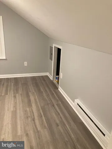 an empty room with wooden floor