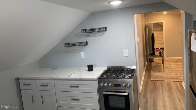 a kitchen with granite countertop a stove and a refrigerator