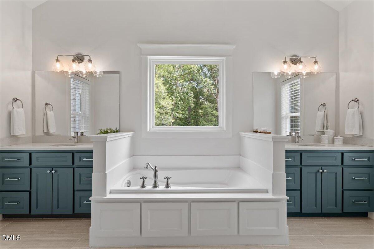595 Billets Run Moncure, NC 27559 - Photo 31 of 54 a bathroom with a double vanity sink mirror and a bathtub