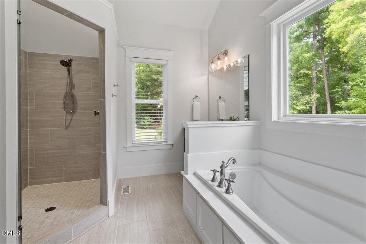 595 Billets Run Moncure, NC 27559 - Photo 32 of 54 a bathroom with a tub a sink and a shower