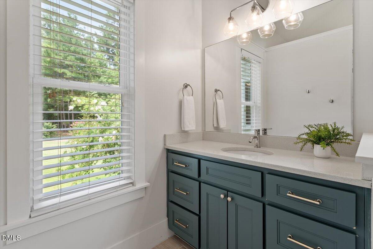 595 Billets Run Moncure, NC 27559 - Photo 33 of 54 a bathroom with a double vanity sink a mirror and a window