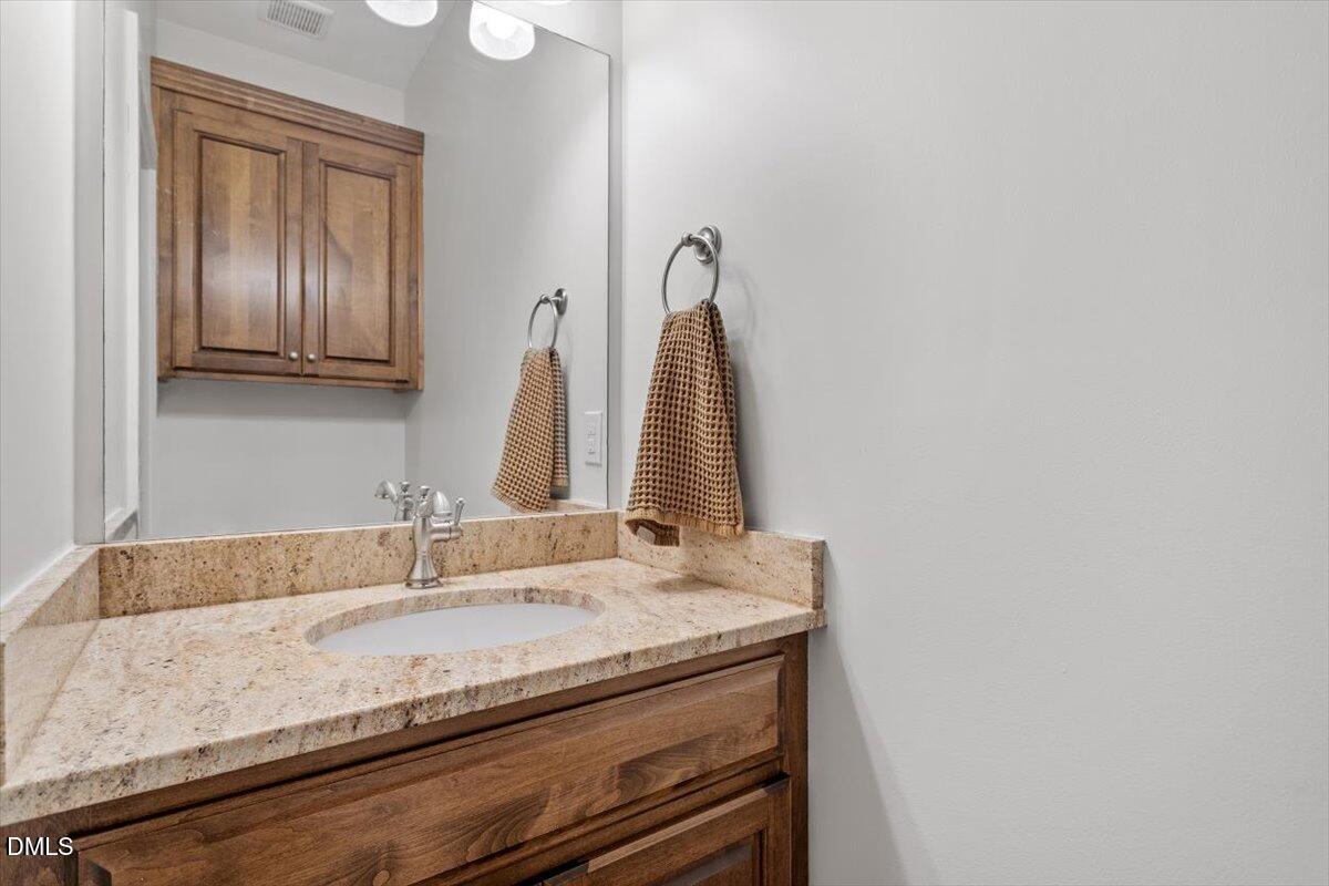 595 Billets Run Moncure, NC 27559 - Photo 47 of 54 a bathroom with a granite countertop sink and a mirror