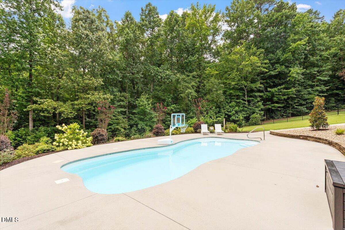 595 Billets Run Moncure, NC 27559 - Photo 9 of 54 a view of a swimming pool and trees in the background