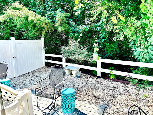 a view of backyard with green space and wooden fence