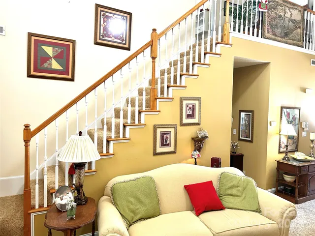 a living room with furniture and a chandelier