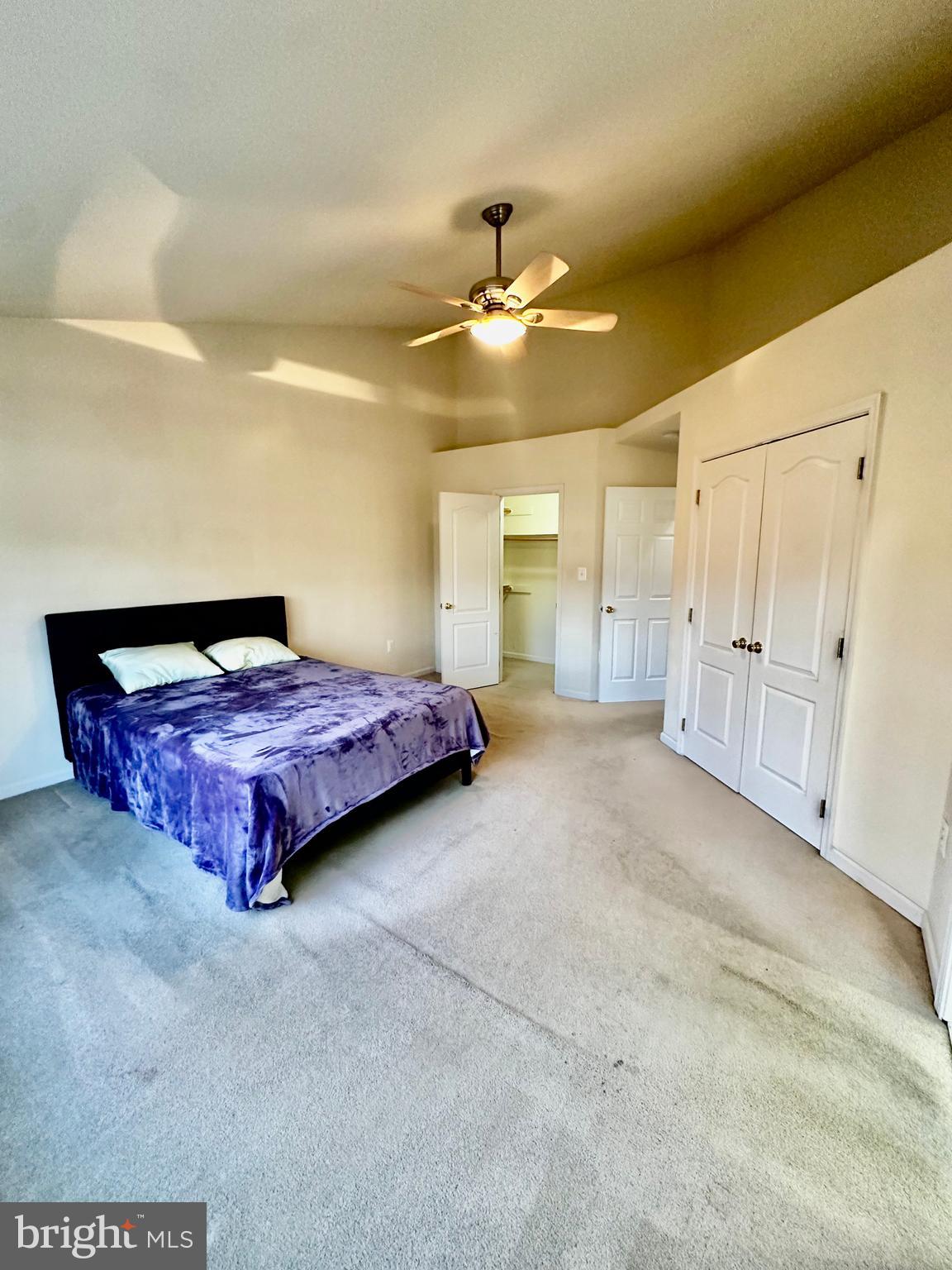 43438 Oxen Lane Chantilly, VA 20152 - Photo 27 of 49 a spacious bedroom with a bed and ceiling fan