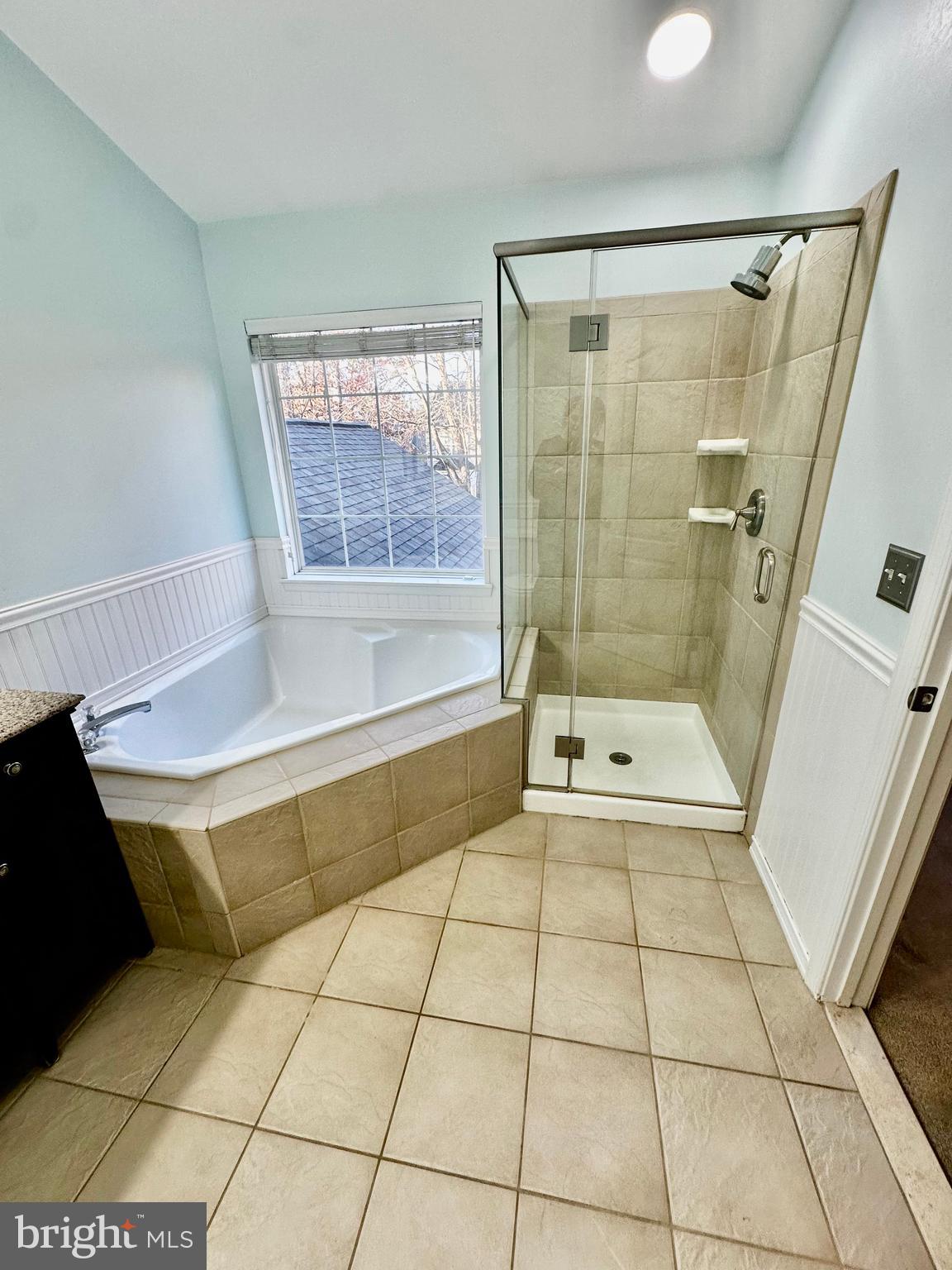 43438 Oxen Lane Chantilly, VA 20152 - Photo 29 of 49 a bathroom with a bathtub and a shower