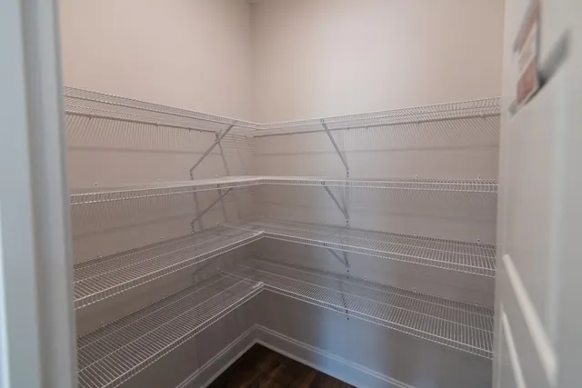 a kitchen with granite countertop a sink and a wooden floor