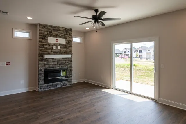 a living room with hard wood floors and a kitchen