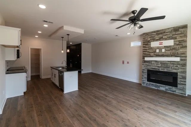 a kitchen with cabinets and wooden floor