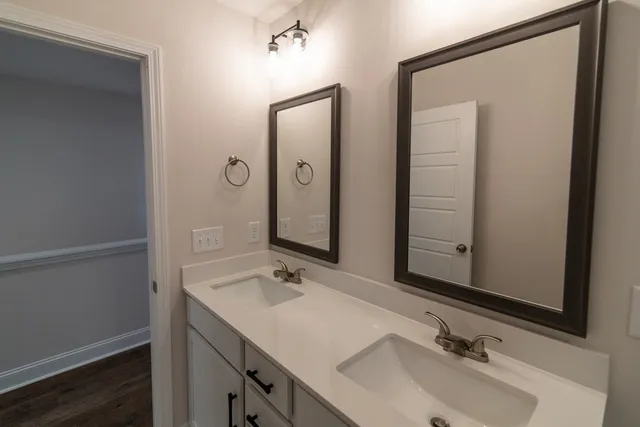 a sign board with tall trees