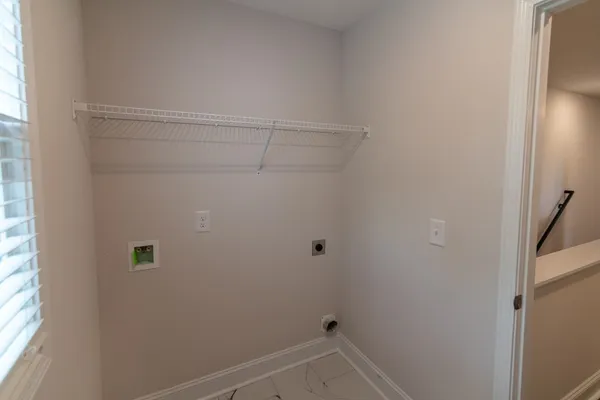 a front view of a house with a yard table and chairs