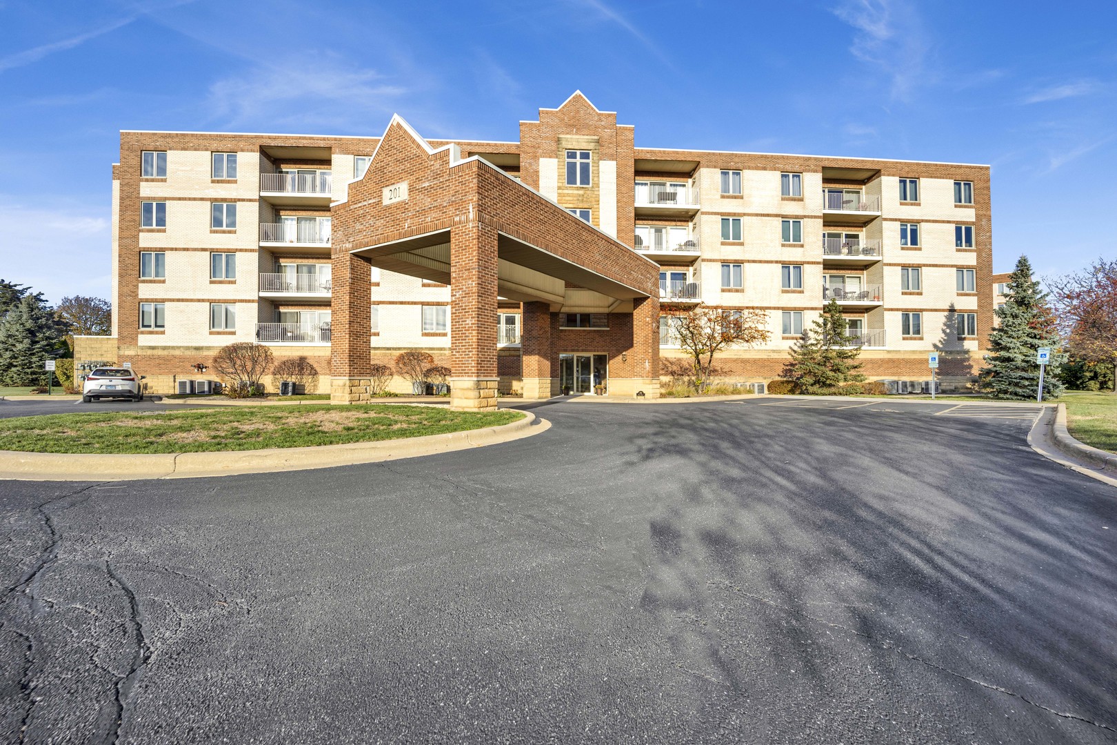 201 West Brush Hill Road, Unit 203 Elmhurst, IL 60126 - Photo 23 of 24 a front view of a building with a swimming pool