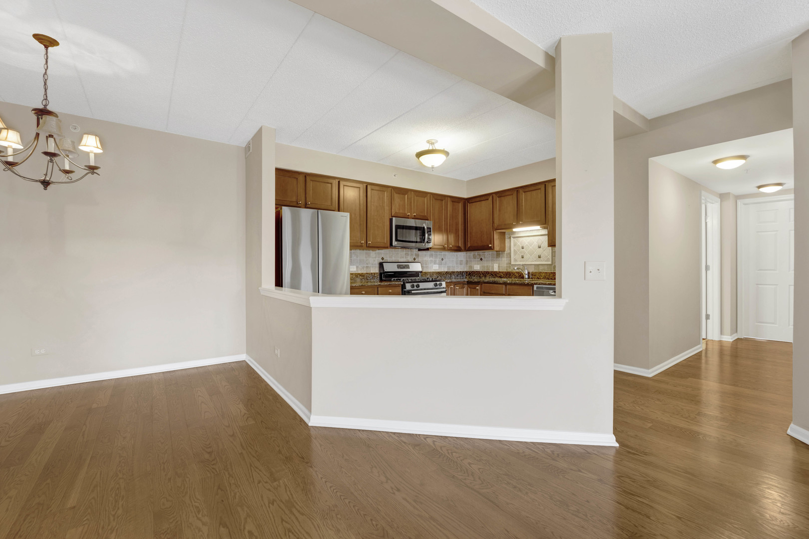 201 West Brush Hill Road, Unit 203 Elmhurst, IL 60126 - Photo 6 of 24 a view of kitchen with refrigerator and microwave