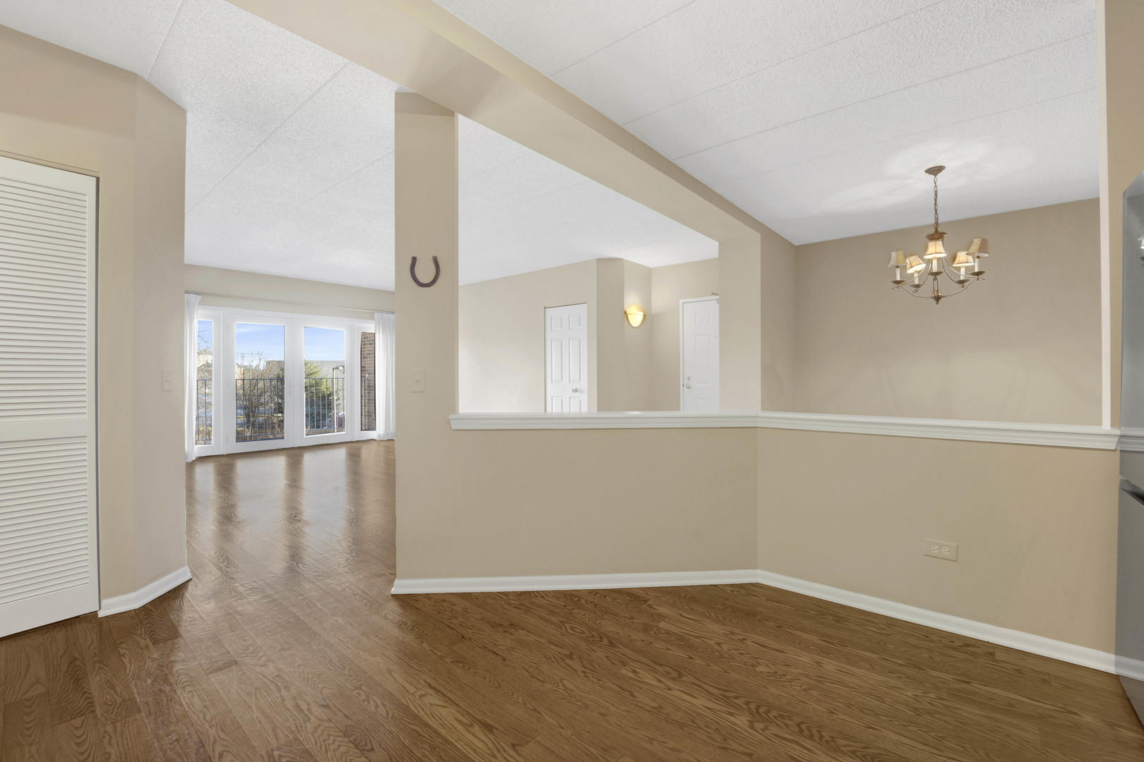 201 West Brush Hill Road, Unit 203 Elmhurst, IL 60126 - Photo 10 of 24 wooden floor in an empty room with a window