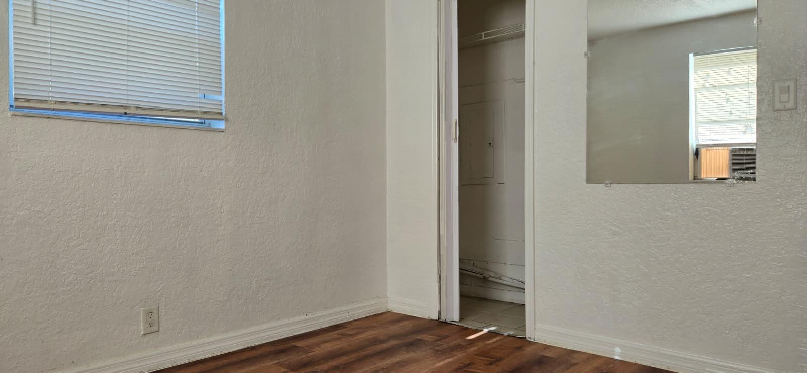 112 Newton Road West Park, FL 33023 - Photo 17 of 31 a view of a small space with wooden floor and a window