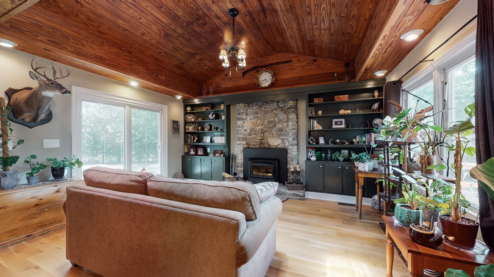 a living room with furniture a fireplace and a potted plant