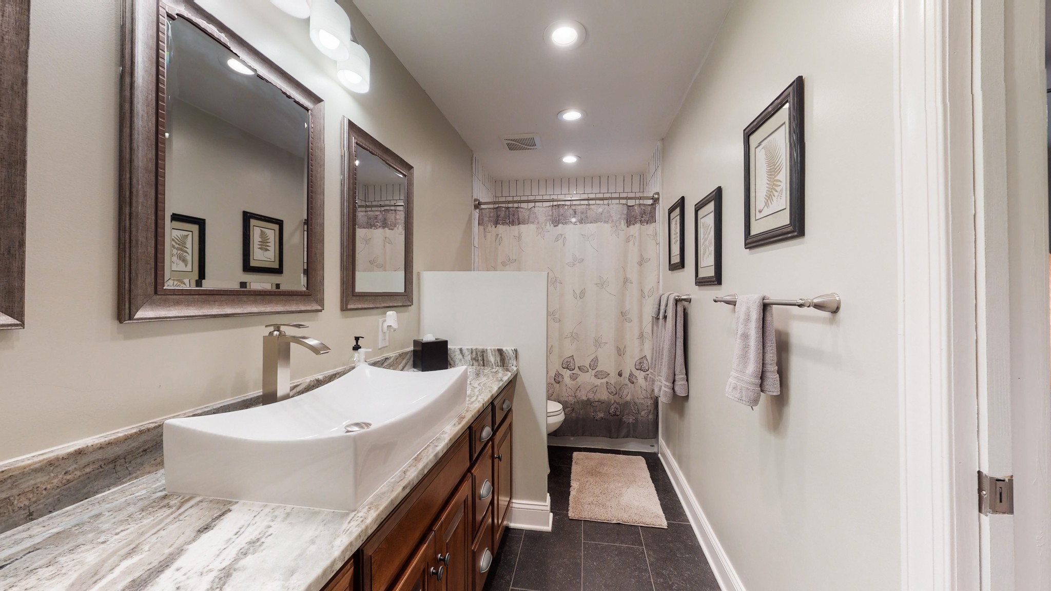 712 Spring Creek Road Lebanon, TN 37087 - Photo 11 of 33 a bathroom with a granite countertop sink a mirror a vanity and shower