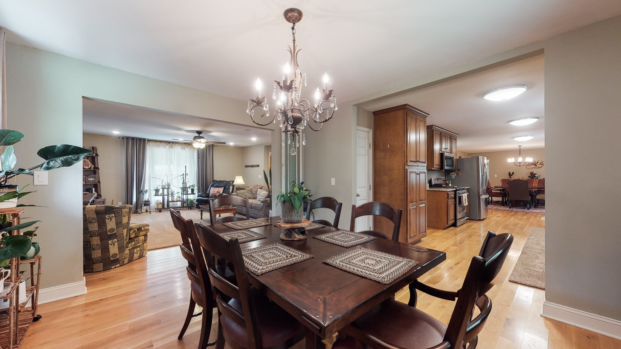 712 Spring Creek Road Lebanon, TN 37087 - Photo 4 of 33 a view of a dining room and livingroom with furniture wooden floor a chandelier