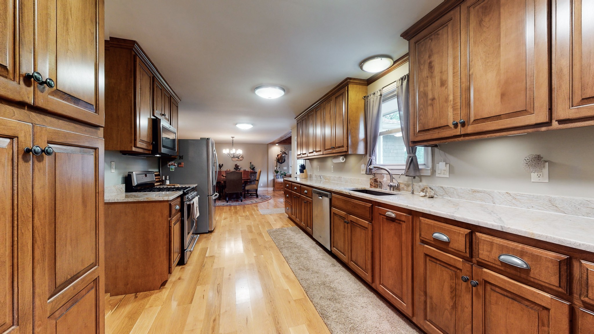 712 Spring Creek Road Lebanon, TN 37087 - Photo 5 of 33 a large kitchen with stainless steel appliances wooden cabinets a sink and a stove