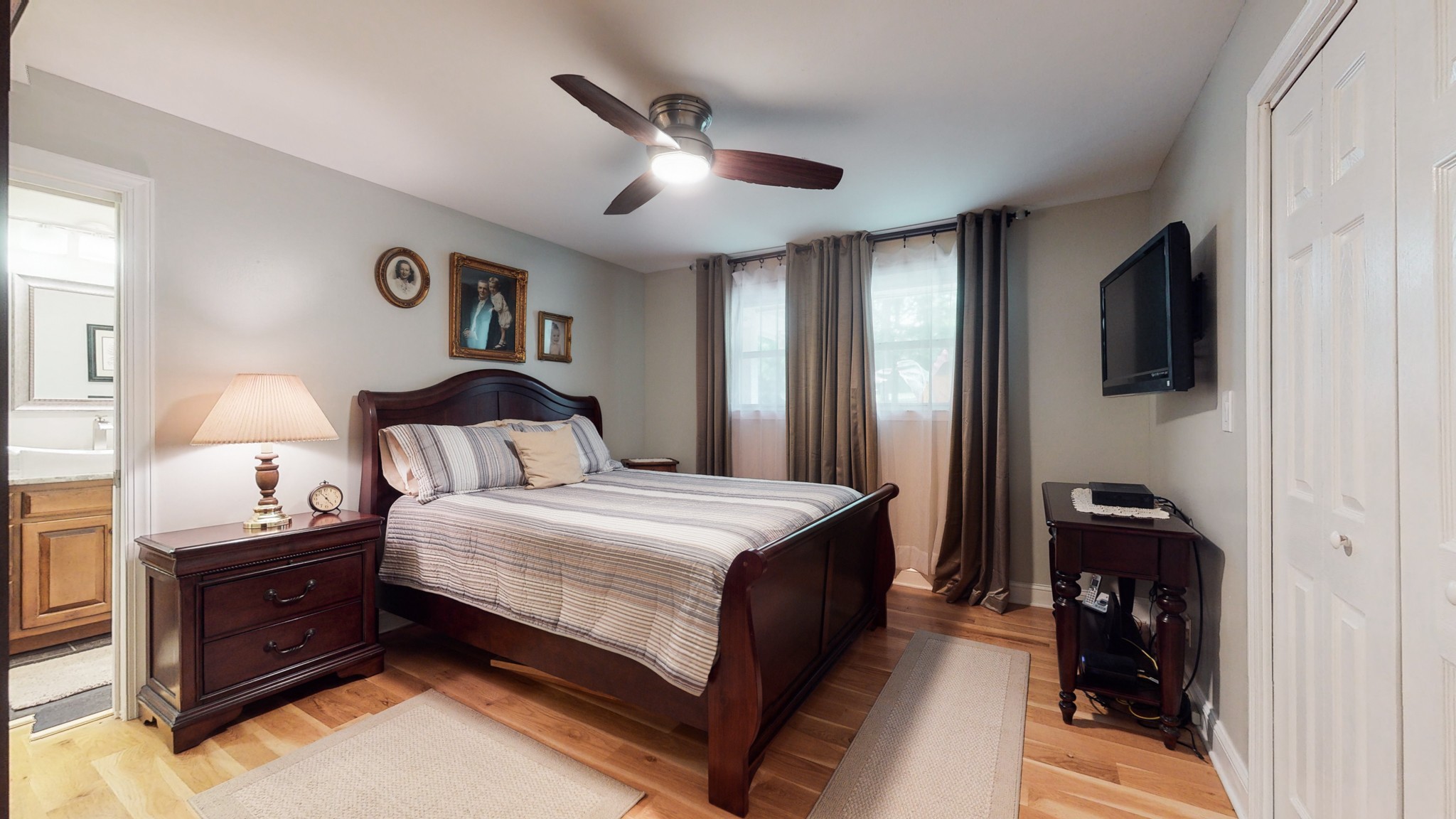 712 Spring Creek Road Lebanon, TN 37087 - Photo 10 of 33 a bedroom with a bed and a flat tv screen on dresser