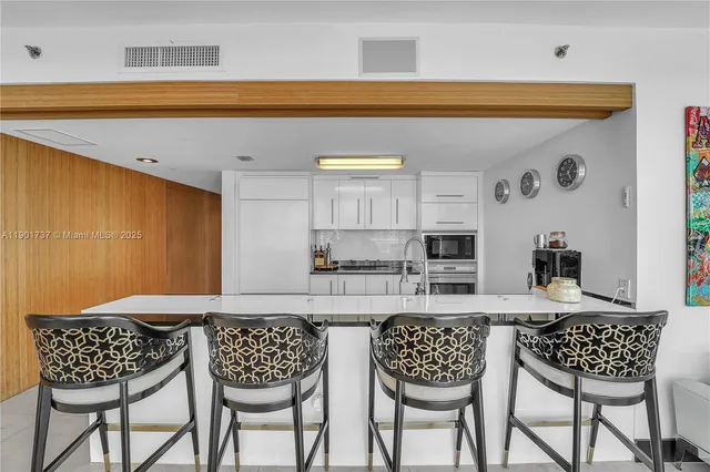 a kitchen with a dining table and chairs