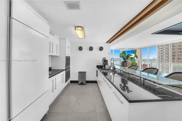 a kitchen with stainless steel appliances granite countertop a sink and a stove